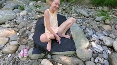 Babe Sarah Fucks a Blue Dildo at Public River.